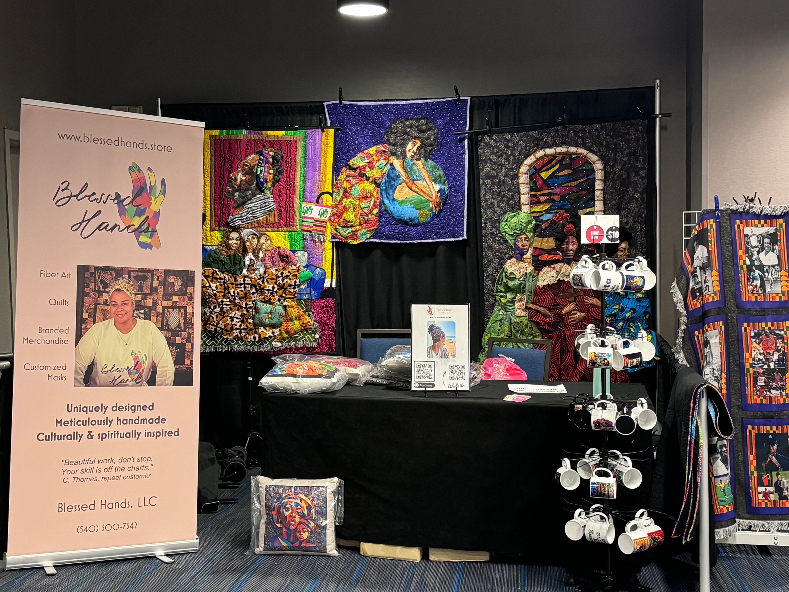 Blessed Hands art booth display with quilts and fiber art